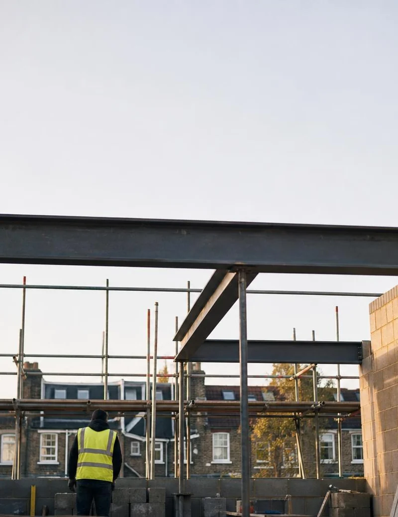 Rear extension under construction with steel beams and scaffolding