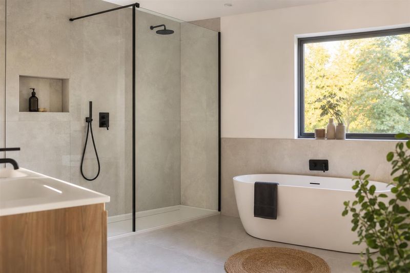 Newly fitted bathroom with walk-in shower and freestanding bath
