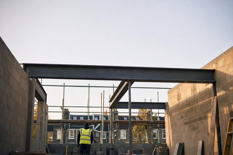 Rear extension under construction with steel beams and scaffolding