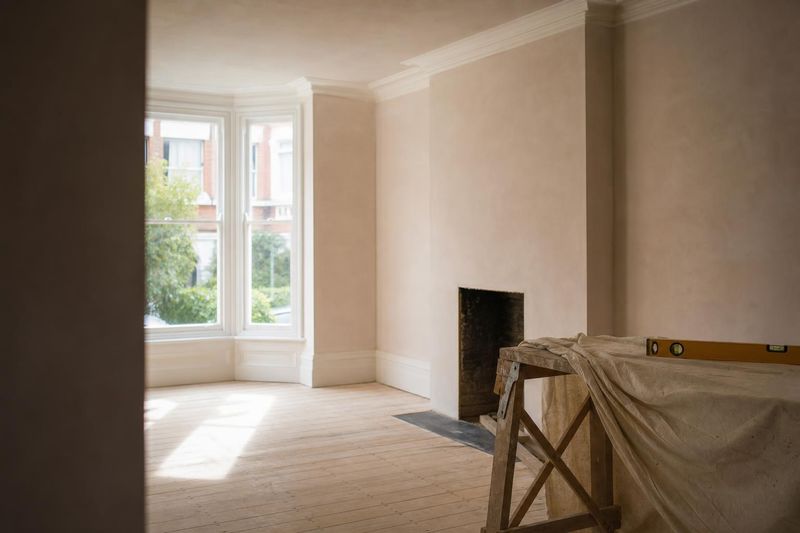 Freshly renovated Victorian living room with sanded floorboards and new plaster